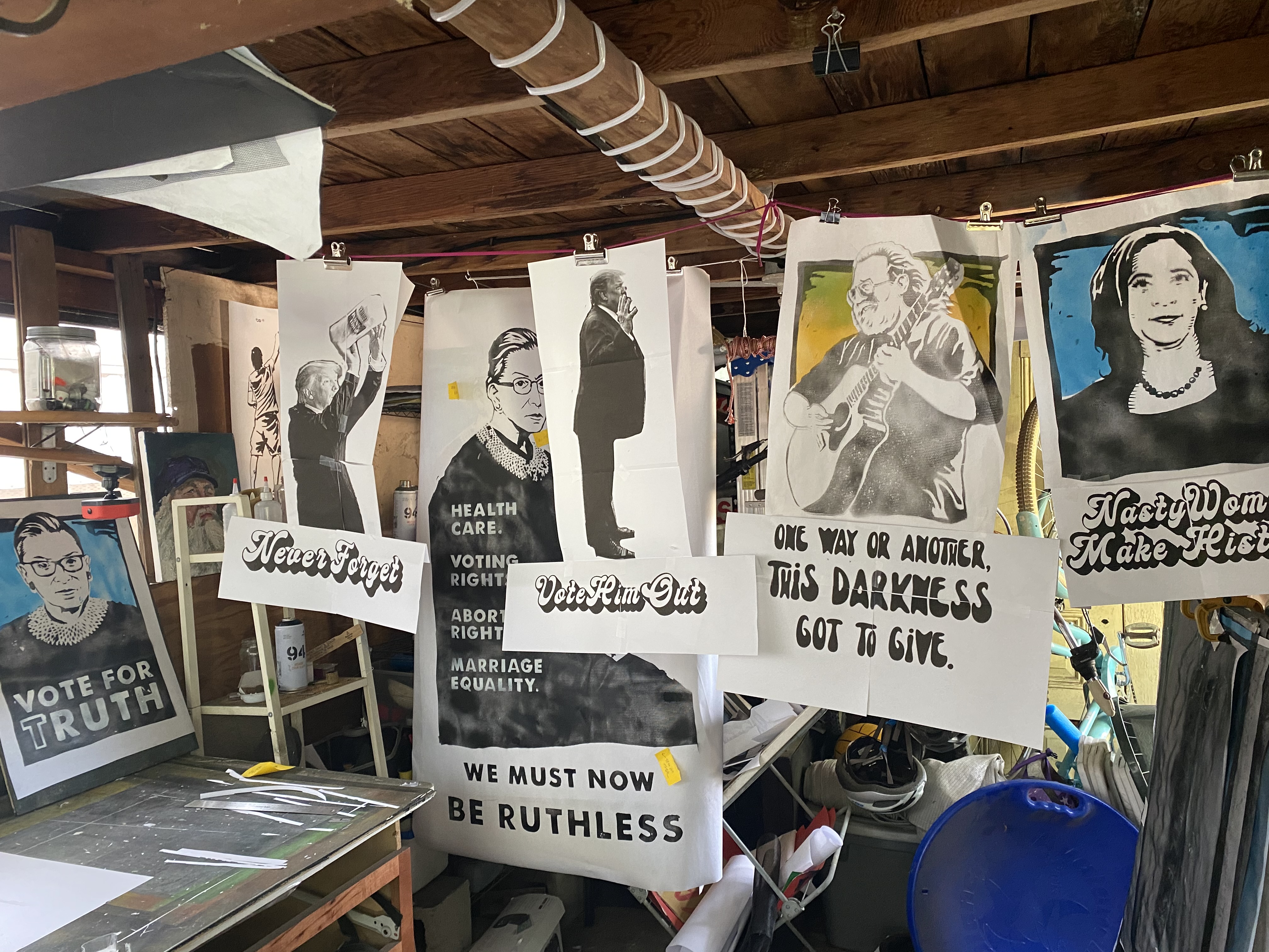 Stencil prints hanging in the studio
